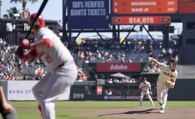 San Francisco Giants pitcher Hayden Birdsong, right, throws against St. Louis Cardinals' Lars Nootbaar, left, during the first inning of a baseball game Sunday, Sept. 29, 2024, in San Francisco. (AP Photo/Tony Avelar)