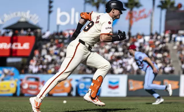 San Francisco Giants' Tyler Fitzgerald (49) sprints towards first on an infield single during the eighth inning of a baseball game against the St. Louis Cardinals in San Francisco, Saturday, Sept. 28, 2024. (Stephen Lam/San Francisco Chronicle via AP)