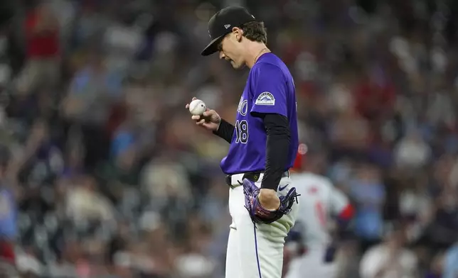 Colorado Rockies starting pitcher Ryan Feltner reacts after giving up a two-run home run to St. Louis Cardinals' Masyn Winn in the third inning of a baseball game Tuesday, Sept. 24, 2024, in Denver. (AP Photo/David Zalubowski)