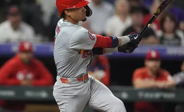 St. Louis Cardinals' Masyn Winn follows the flight of his two-run home run off Colorado Rockies starting pitcher Ryan Feltner in the third inning of a baseball game Tuesday, Sept. 24, 2024, in Denver. (AP Photo/David Zalubowski)