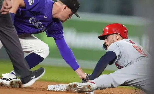 Colorado Rockies second baseman Aaron Schunk, left, applies a late tag as St. Louis Cardinals' Michael Siani steals second base in the third inning of a baseball game Tuesday, Sept. 24, 2024, in Denver. (AP Photo/David Zalubowski)