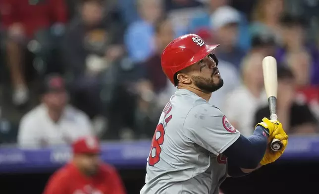 St. Louis Cardinals' Iván Herrera singles against Colorado Rockies starting pitcher Ryan Feltner in the second inning of a baseball game Tuesday, Sept. 24, 2024, in Denver. (AP Photo/David Zalubowski)