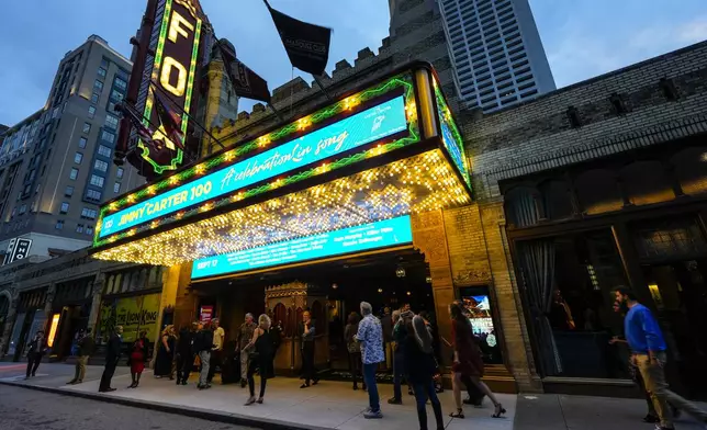 People wait in line ahead of a "Jimmy Carter 100: A Celebration in Song," concert at the Fox Theatre, Tuesday, Sept. 17, 2024, in Atlanta. Former President Carter turns 100-years old on Oct. 1. (AP Photo/Mike Stewart)