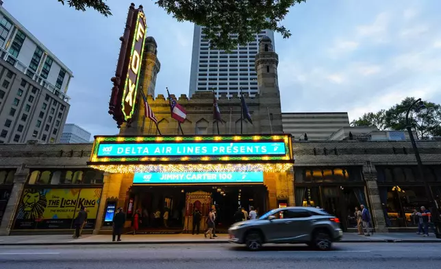 People wait in line ahead of a "Jimmy Carter 100: A Celebration in Song," concert at the Fox Theatre, Tuesday, Sept. 17, 2024, in Atlanta. Former President Carter turns 100-years old on Oct. 1. (AP Photo/Mike Stewart)