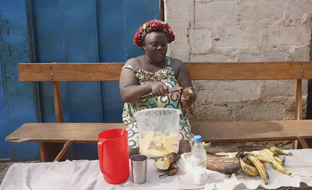 A woman prepares plantains to sell in the market in Bangui, Central African Republic, on March 11, 2024. (AP Photo/Sam Mednick)