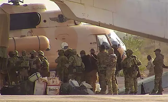 FILE - This undated photograph handed out by French military shows Russian mercenaries boarding a helicopter in northern Mali. (French Army via AP, File)