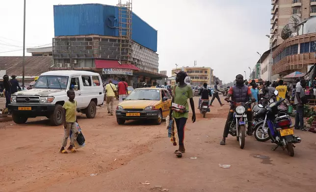 People walk on the streets in Bangui, Central African Republic, on March 11, 2024. (AP Photo/Sam Mednick)