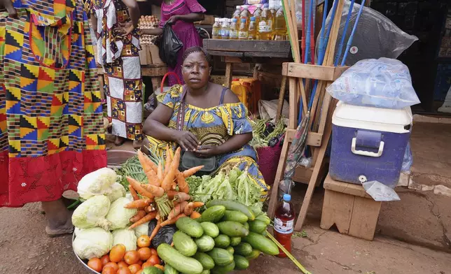 A woman sells vegetables at a market in Bangui, Central African Republic, on March 11, 2024. (AP Photo/Sam Mednick)