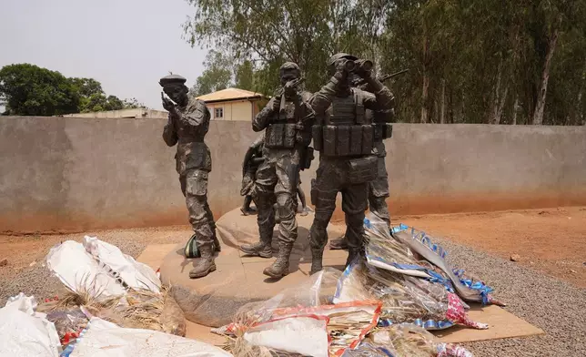 Flowers are laid at the statue of Russian mercenaries as a tribute to the late Wagner leader Yevgeny Prigozhin in Bangui, Central African Republic, on March. 5, 2024. (AP Photo/Sam Mednick)