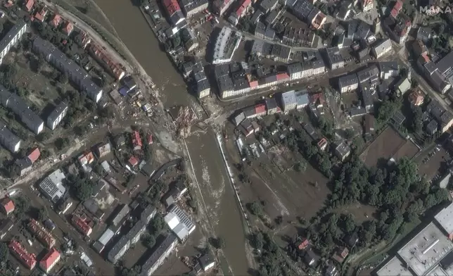 This satellite image released by Maxar Technologies shows floodwaters and debris after record rains in Glucholazy, Poland, Tuesday, Sept. 17, 2024. (Satellite image ©2024 Maxar Technologies via AP)