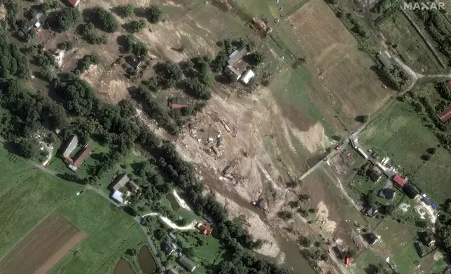 This satellite image released by Maxar Technologies shows flooded fields and damaged homes after record rains along the Biala Ladecka River in Stronie Slaskie, Poland, Tuesday, Sept. 17, 2024. (Satellite image ©2024 Maxar Technologies via AP)