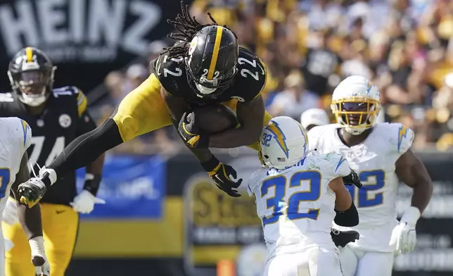 Pittsburgh Steelers running back Najee Harris (22) tries to hurdle Los Angeles Chargers safety Alohi Gilman (32) during the second half of an NFL football game, Sunday, Sept. 22, 2024, in Pittsburgh. (AP Photo/Matt Freed)