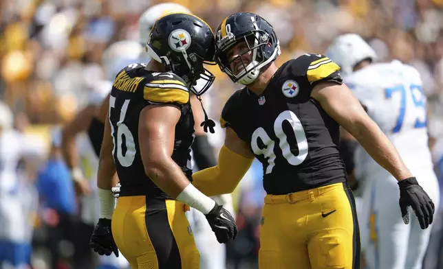 Pittsburgh Steelers linebackers Alex Highsmith, left, and T.J. Watt celebrate during the first half of an NFL football game against the Los Angeles Chargers, Sunday, Sept. 22, 2024, in Pittsburgh. (AP Photo/Name)