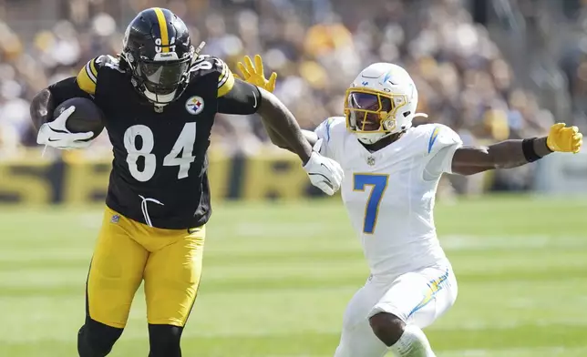 Pittsburgh Steelers running back Cordarrelle Patterson, left, runs with the ball against Los Angeles Chargers cornerback Kristian Fulton, right, during the second half of an NFL football game, Sunday, Sept. 22, 2024, in Pittsburgh. (AP Photo/Matt Freed)