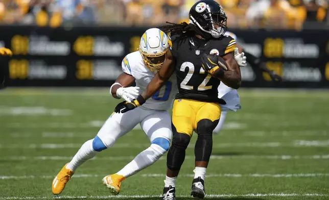 Pittsburgh Steelers running back Najee Harris, right, is tackled by Los Angeles Chargers linebacker Daiyan Henley, left, during the first half of an NFL football game, Sunday, Sept. 22, 2024, in Pittsburgh. (AP Photo/Gene J. Puskar)