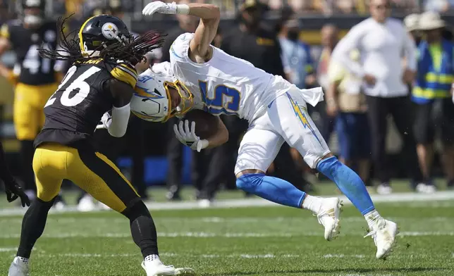 Pittsburgh Steelers cornerback Donte Jackson, left, tackles Los Angeles Chargers wide receiver Ladd McConkey during the first half of an NFL football game, Sunday, Sept. 22, 2024, in Pittsburgh. (AP Photo/Matt Freed)