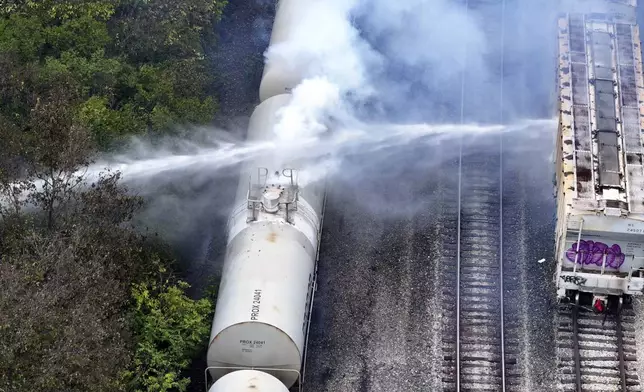 Firefighters work on the scene of a chemical leak in railcars near Cleves, Ohio, Tuesday, Sept. 24, 2024. (Local 12/WKRC via AP)