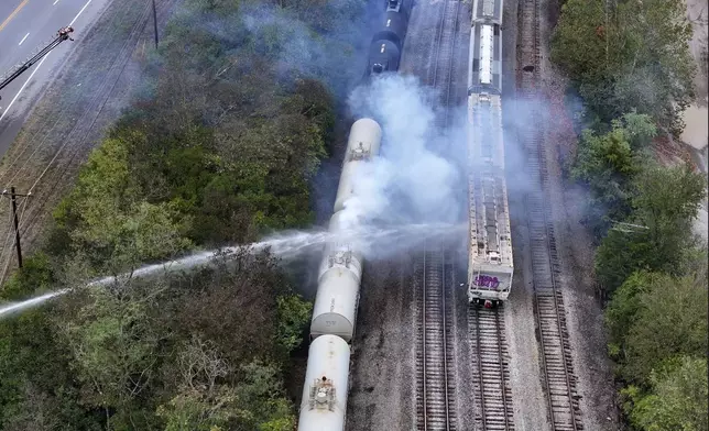 Firefighters work on the scene of a chemical leak in railcars near Cleves, Ohio, Tuesday, Sept. 24, 2024. (Local 12/WKRC via AP)