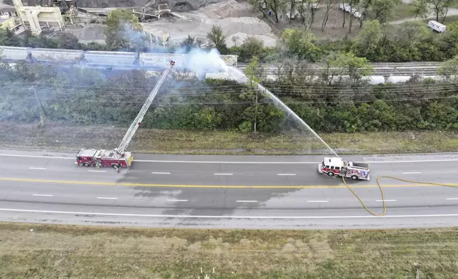 Firefighters work on the scene of a chemical leak in railcars near Cleves, Ohio, Tuesday, Sept. 24, 2024. (Local 12/WKRC via AP)