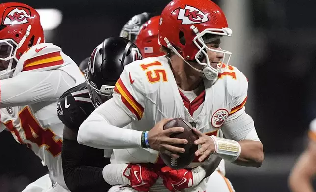 Kansas City Chiefs quarterback Patrick Mahomes (15) is hit by Atlanta Falcons linebacker Arnold Ebiketie (17) during the first half of an NFL football game, Sunday, Sept. 22, 2024, in Atlanta. (AP Photo/Brynn Anderson)