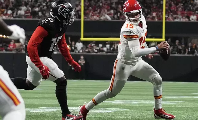 Kansas City Chiefs quarterback Patrick Mahomes (15) runs out of the pocket as Atlanta Falcons linebacker Matthew Judon (15) defends during the second half of an NFL football game, Sunday, Sept. 22, 2024, in Atlanta. (AP Photo/Brynn Anderson)