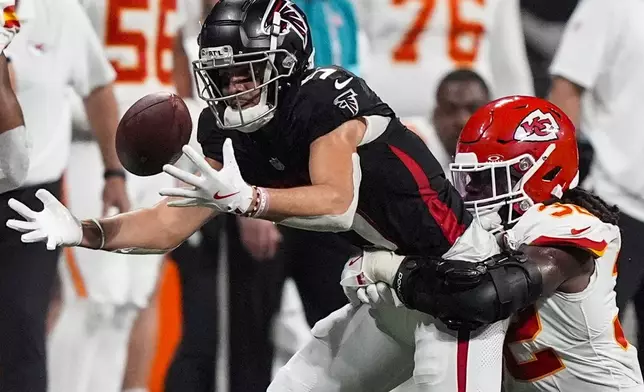 Atlanta Falcons wide receiver Drake London (5) loses the ball but recovers against Kansas City Chiefs linebacker Nick Bolton (32) during the second half of an NFL football game, Sunday, Sept. 22, 2024, in Atlanta. (AP Photo/Brynn Anderson)