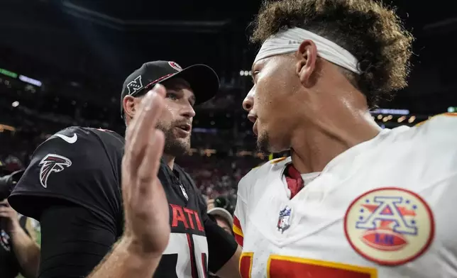 Atlanta Falcons quarterback Kirk Cousins speaks with Kansas City Chiefs quarterback Patrick Mahomes after an NFL football game, Sunday, Sept. 22, 2024, in Atlanta. The Kansas City Chiefs 22-17. (AP Photo/Brynn Anderson)