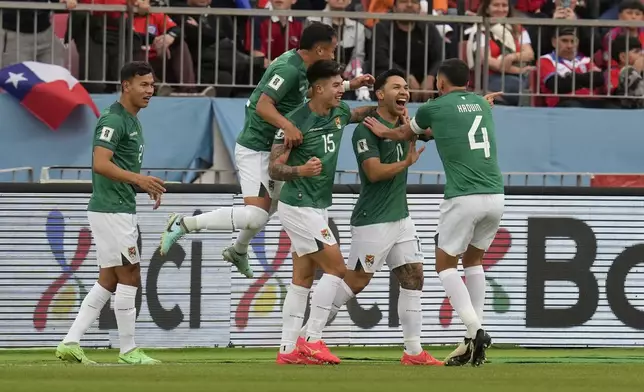 Bolivia's Carmelo Algaranaz, second from right, celebrates with teammates after scoring his side's opening goal against Chile during a qualifying soccer match for the FIFA World Cup 2026 at the National Stadium in Santiago, Chile, Tuesday, Sept. 10, 2024. (AP Photo/Esteban Felix)