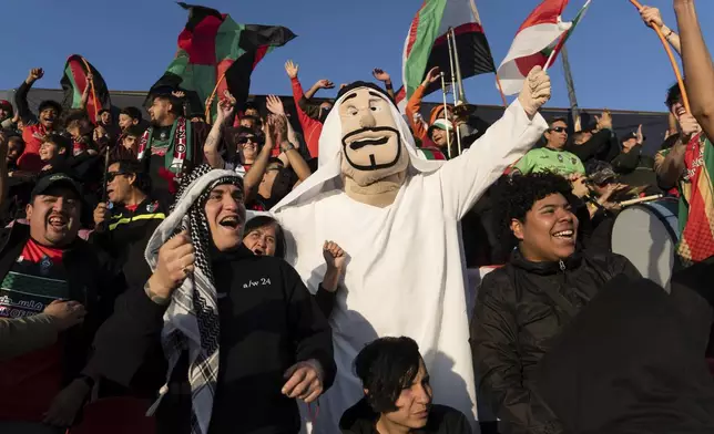 Club Palestino soccer team fans celebrate their victory over Santiago Wanderers at a local league match at La Cisterna stadium in Santiago, Chile, Friday, July 12, 2024. (AP Photo/Matias Basualdo)