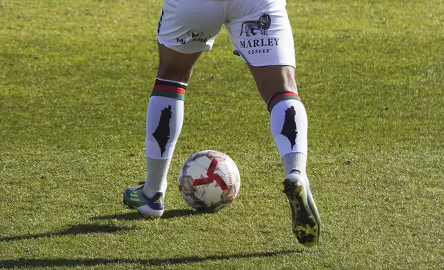 A Club Palestino player wears socks with an outline of territory Palestinians claim as theirs during a local league soccer match against Santiago Wanderers at La Cisterna stadium in Santiago, Chile, Friday, July 12, 2024. (AP Photo/Matias Basualdo)