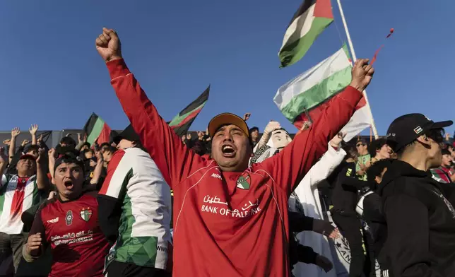 Club Palestino soccer team fans celebrate their second goal against Santiago Wanderers at a local league match at La Cisterna stadium in Santiago, Chile, Friday, July 12, 2024. (AP Photo/Matias Basualdo)