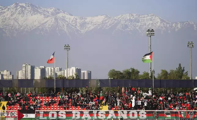 Club Palestino supporters watch a local league match against Santiago Wanderers at La Cisterna stadium in Santiago, Chile, Friday, July 12, 2024. (AP Photo/Matias Basualdo)