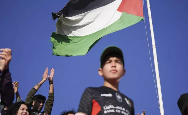 Club Palestino soccer team fans watch their team's game with Santiago Wanderers at a local league match at La Cisterna stadium in Santiago, Chile, Friday, July 12, 2024. (AP Photo/Matias Basualdo)