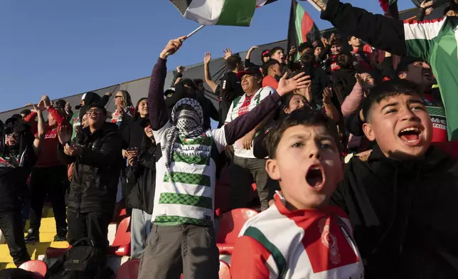 Club Palestino soccer team fans celebrate their second goal against Santiago Wanderers at a local league match at La Cisterna stadium in Santiago, Chile, Friday, July 12, 2024. (AP Photo/Matias Basualdo)