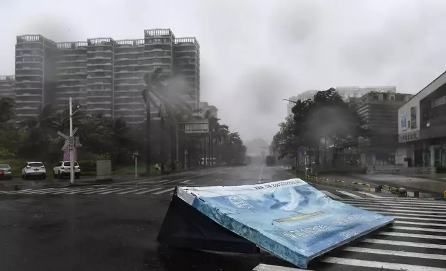 In this photo released by Xinhua News Agency, an advertisement billboard lands on a road following the landfall of typhoon Yagi in Haikou, south China's Hainan Province, Friday, Sept. 6, 2024. (Yang Guanyu/Xinhua via AP)