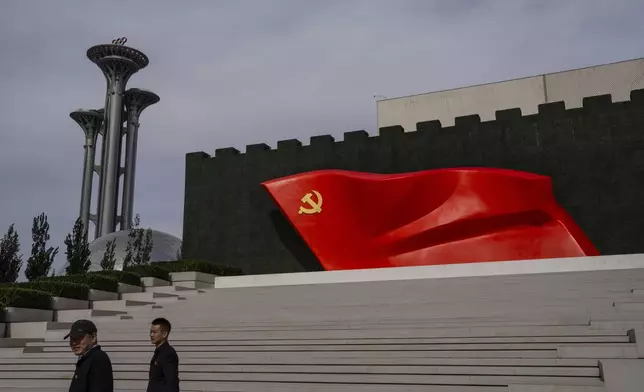 FILE - Visitors pass the Chinese Communist Party flag at the museum of the Communist Party of China in Beijing, Oct. 19, 2023. (AP Photo/Louise Delmotte, File)