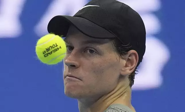 Jannick Sinner of Italy tosses a ball as he waits for play against Roman Safiullin of Russia during the China Open tennis tournament held at the National Tennis Center in Beijing, Saturday, Sept. 28, 2024. (AP Photo/Ng Han Guan)
