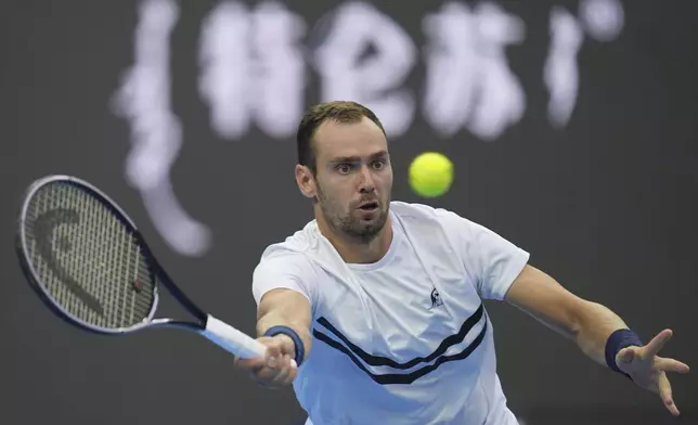 Roman Safiullin of Russia returns a shot from Jannick Sinner of Italy during the China Open tennis tournament held at the National Tennis Center in Beijing, Saturday, Sept. 28, 2024. (AP Photo/Ng Han Guan)