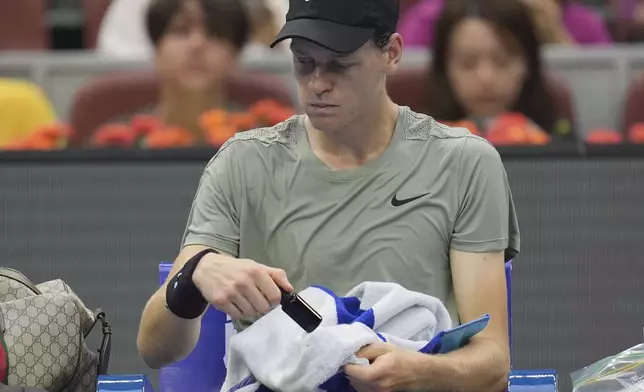 Italy's Jannick Sinner rests between sets against Roman Safiullin of Russia during the China Open tennis tournament held at the National Tennis Center in Beijing, Saturday, Sept. 28, 2024. (AP Photo/Ng Han Guan)