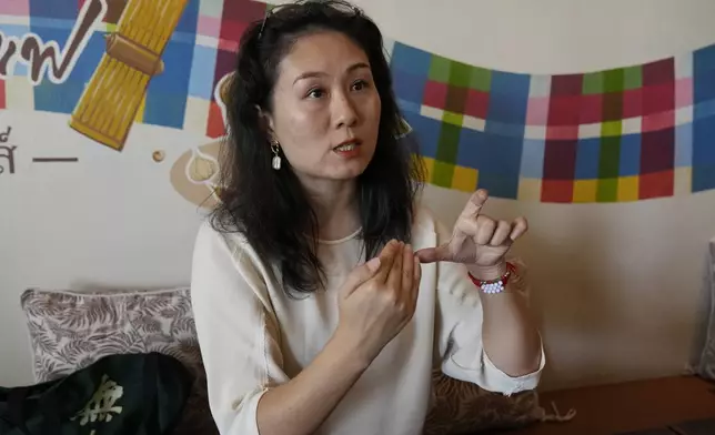 Chinese mother Du Xuan gestures during an interview with The Associated Press in Chiang Mai province, Thailand, Tuesday, April 23, 2024. (AP Photo/Sakchai Lalit)