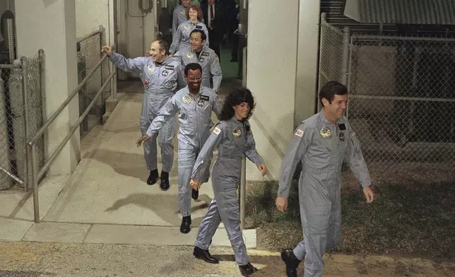 FILE - The crew for the Space Shuttle Challenger flight 51-L leaves their quarters for the launch pad, Jan. 27, 1986, at the Kennedy Space Center in Florida. Front to back are Commander Francis Scobee, Mission Spl. Judith Resnik, Mission Spl. Ronald McNair, Payload Spl. Gregory Jarvis, Mission Spl. Ellison Onizuka, teacher Christa McAuliffe, and pilot Michael Smith. (AP Photo/Steve Helber, File)