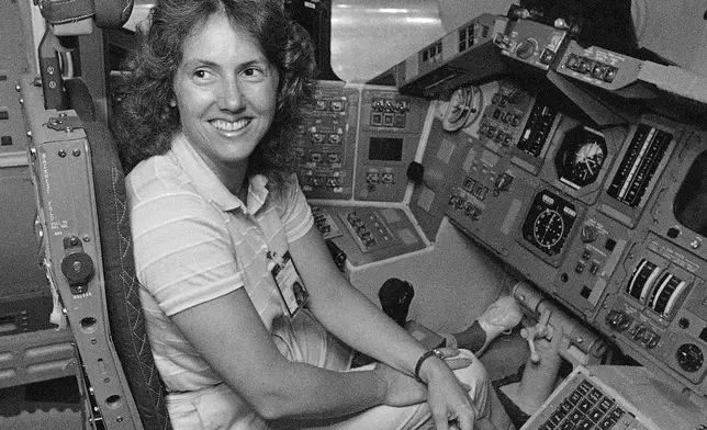 FILE - In this Sept. 13, 1985 file photo, Christa McAuliffe tries out the commander's seat on the flight deck of a shuttle simulator at the Johnson Space Center in Houston, Texas. (AP Photo, File)