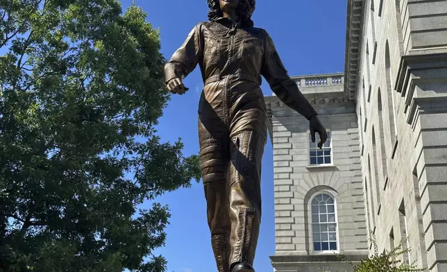 A statue of America's first teacher in space, Christa McAuliffe, who died when the space shuttle Challenger broke apart in 1986, is seen after its unveiling on what would've been her 76th birthday, Monday, Sept. 2, 2024, in Concord, N.H. (AP Photo/Nick Perry)