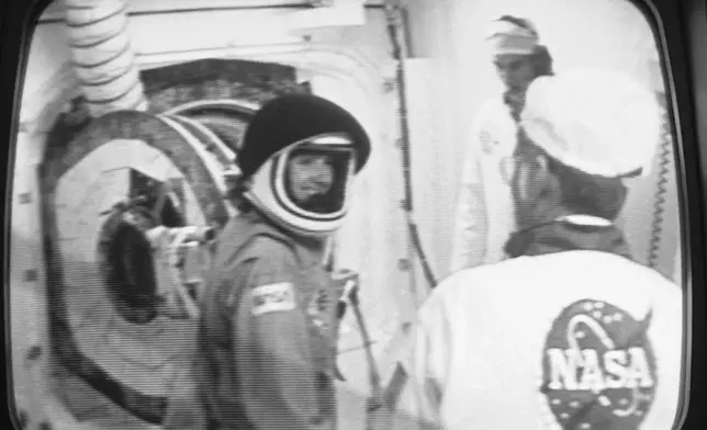 FILE - Teacher Christa McAuliffe smiles after she was suited up for her space flight at the Kennedy Space Center, Florida, Jan. 27, 1986. (NASA via AP, File)