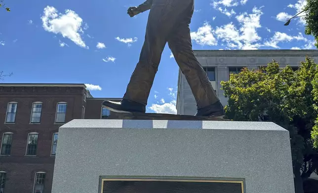 The sun shines on the newly-unveiled statue of Christa McAuliffe at the New Hampshire Statehouse, Monday, Sept. 2, 2024, in Concord, N.H. (AP Photo/Holly Ramer)