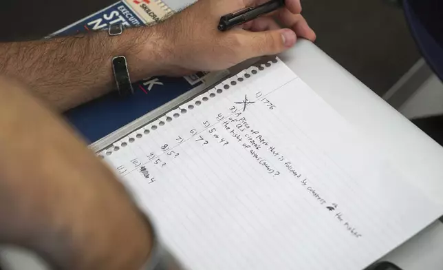 A student checks a classmate's test during an American government class at the University of South Carolina Beaufort in Bluffton, S.C., on Tuesday, Aug. 20, 2024. (AP Photo/Allen G. Breed)