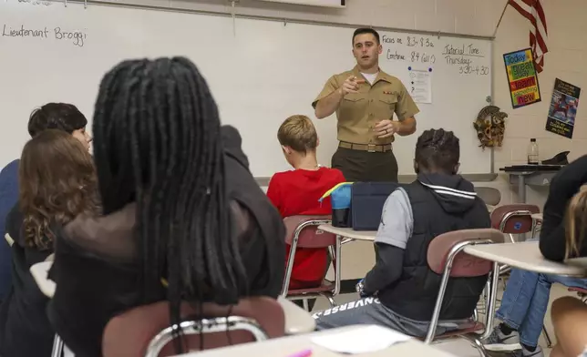 Then-1st Lt. Jameson Broggi, the deputy staff judge advocate with Marine Corps Air Station (MCAS) Cherry Point, answers questions from students about a career in law during its annual eighth grade career day at Tucker Creek Middle School, Havelock, N.C., on Oct. 24, 2022. Broggi, now a captain, has written legislation requiring all public university students to complete a civics class before they can graduate. (Lance Cpl. Symira Bostic/U.S. Marine Corps via AP)