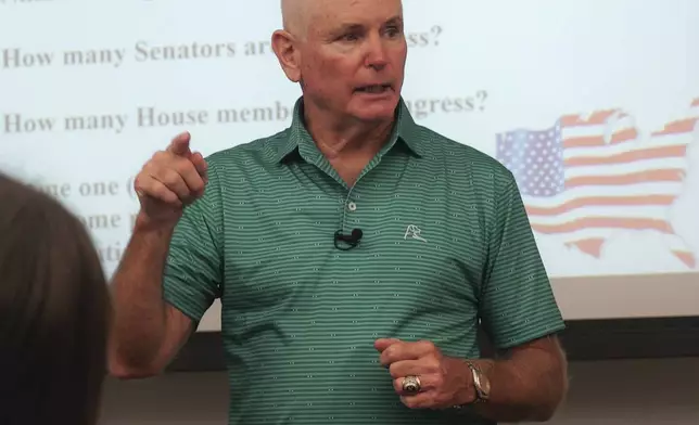 Professor Kevin Dopf lectures his American government students at the University of South Carolina Beaufort in Bluffton, S.C., on Tuesday, Aug. 20, 2024. The retired Arny lieutenant colonel always surprises his students on the first day with a citizenship test, and most of his students flunk. (AP Photo/Allen G. Breed)