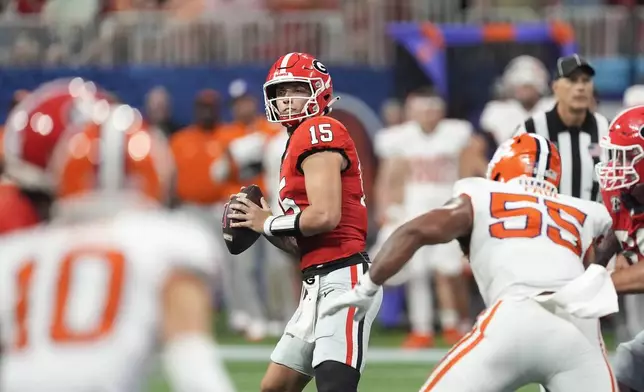 Georgia quarterback Carson Beck (15) throws from the pocket during the second half of an NCAA college football game against Clemson Aug. 31, 2024, in Atlanta. (AP Photo/John Bazemore)