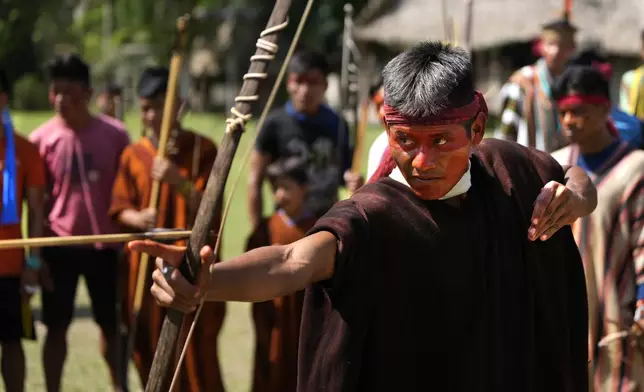 An Ashaninka Indigenous youth participates in a bow and arrow competition during the annual celebration recognizing the Ashaninka territory in the Apiwtxa village, Acre state, Brazil, Sunday, June 23, 2024. (AP Photo/Jorge Saenz)